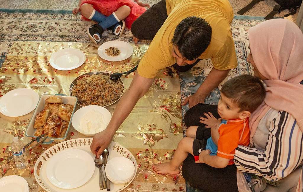 Afghan family prepares a traditional meal