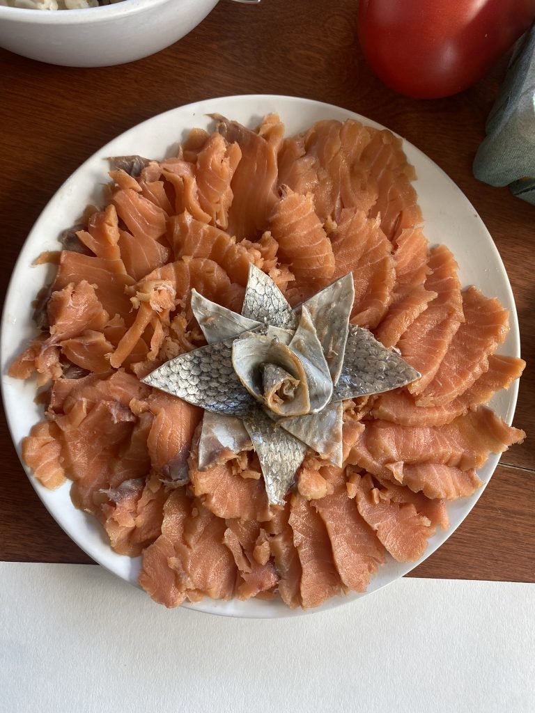 fresh salmon arranged in a flower shape on a plate