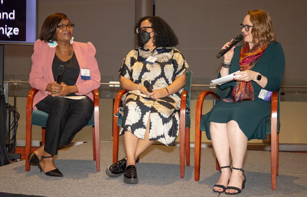 Sam Hatzenbeler at a fundraiser, seated with two other women