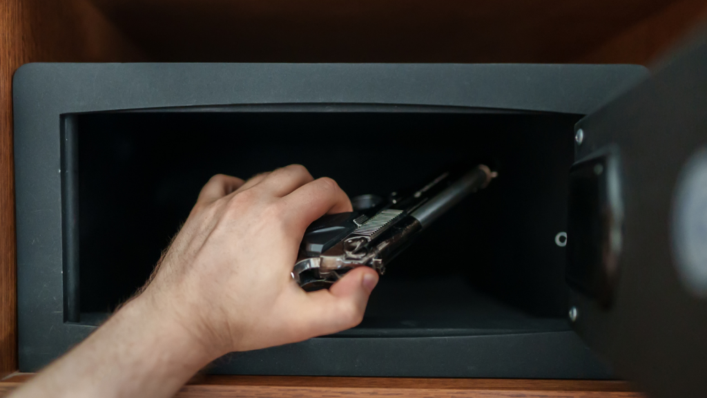 Person places firearm into a lockbox.