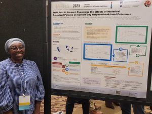 Pamela Bonsu stands by her poster from the IAPHS conference